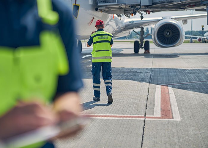 aviation quality control engineers performing a post-flight damage assessment