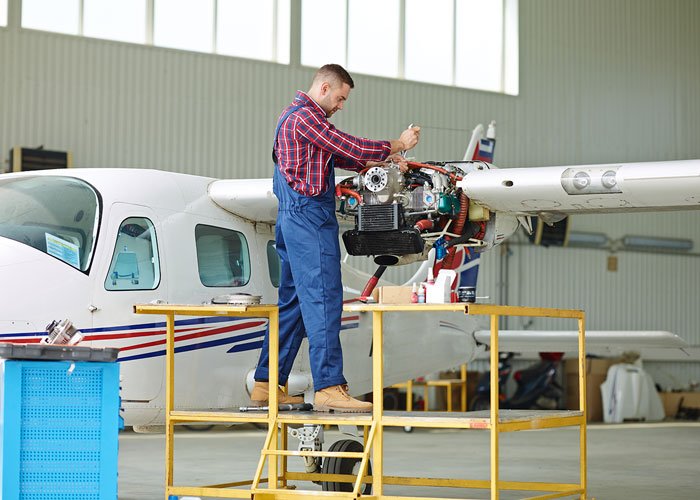 MRO maintenance repair overhaul engineer conducting repairs on a plane wing