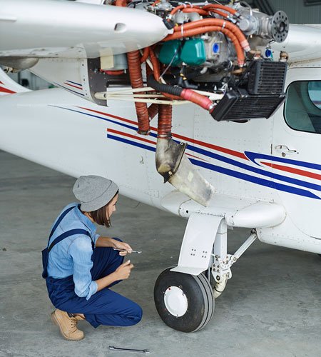 vintage aircraft restoration engineer working on vintage seaplane